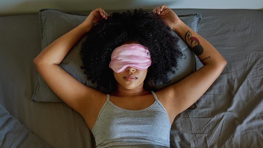 Frau liegt mit Schlafmaske im Bett - Foto: istock/LaylaBird