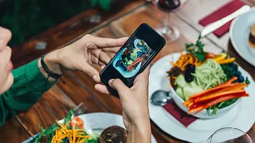 Mädchen fotografieren Essen In einem Restaurant - Foto: microgen/istock Mädchen fotografieren Essen In einem Restaurant - Foto: microgen/istock