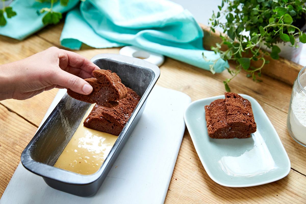 Hasenkuchen Anleitung Bild 3: Hellen Teig auf den Boden der Form verteilen und Schokohasen daraufsetzen