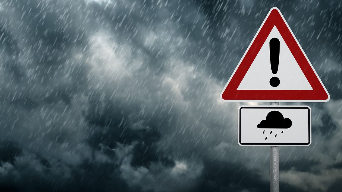 Symbolfoto Unwetter mit Warn-Schild