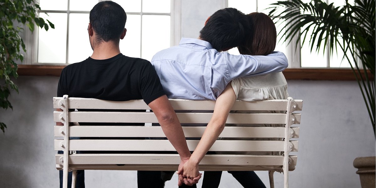 Young woman and man holding their hands behind the seat